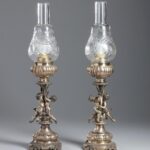 A pair of silver and glass lamps